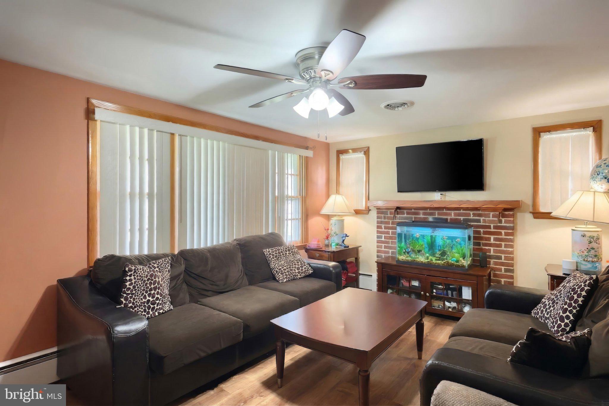 2208 Grandview Road Hanover, PA 17331 - Photo 19 of 39 a living room with furniture a fireplace and a flat screen tv
