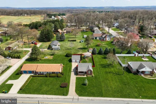 an aerial view of multiple houses with yard