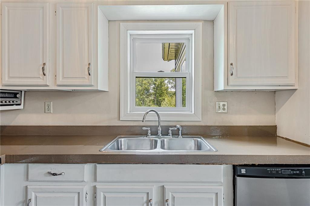 812 Buchanan Road White, PA 15490 - Photo 11 of 35 a kitchen with granite countertop a sink and cabinets