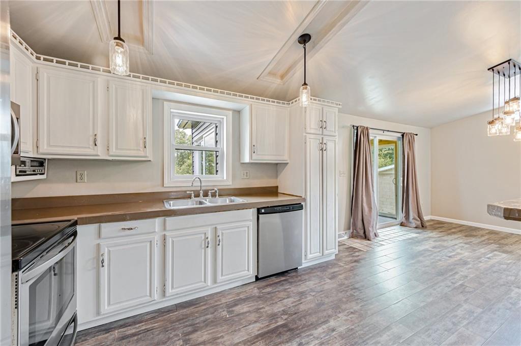 812 Buchanan Road White, PA 15490 - Photo 12 of 35 a kitchen with white cabinets and white appliances