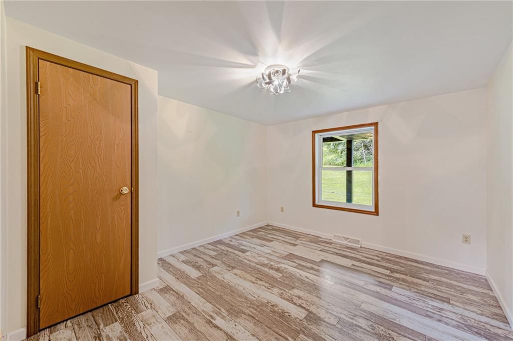 812 Buchanan Road White, PA 15490 - Photo 16 of 35 a view of empty room with window and wooden floor