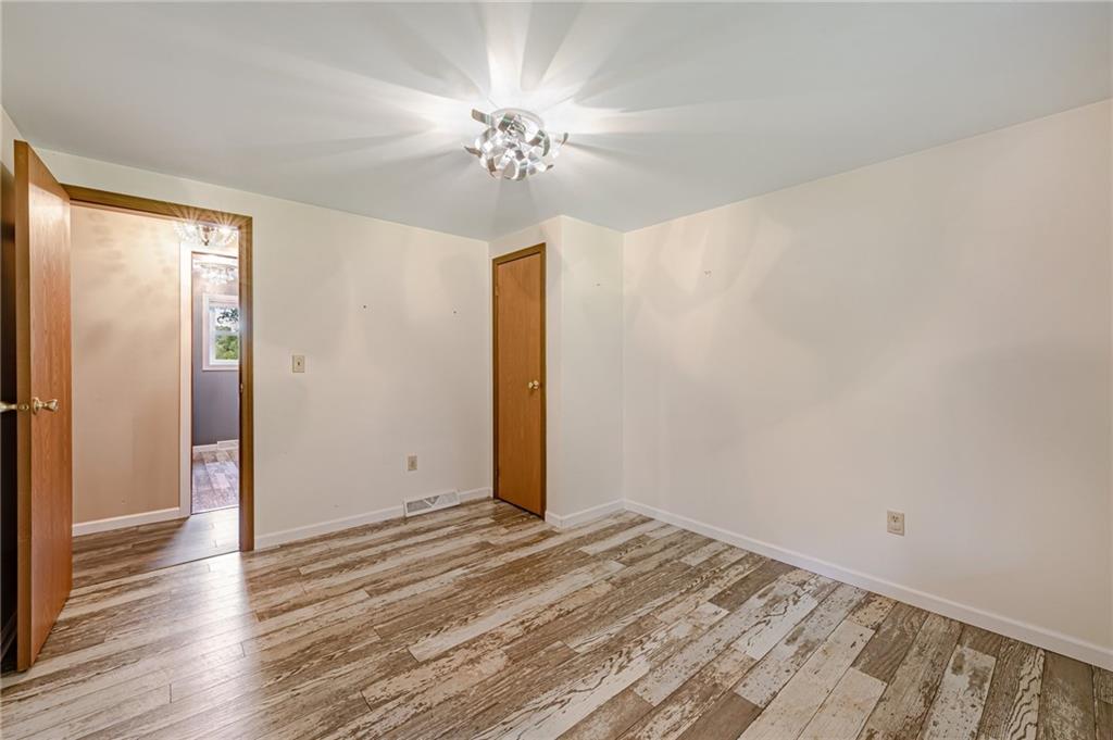 812 Buchanan Road White, PA 15490 - Photo 17 of 35 a view of a livingroom with wooden floor and chandelier