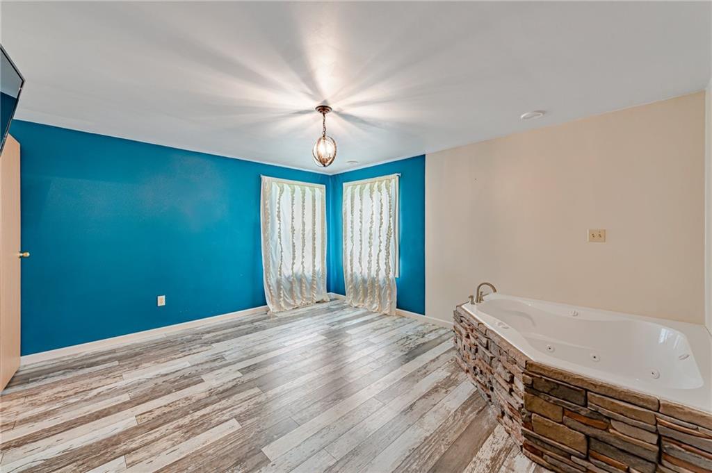 812 Buchanan Road White, PA 15490 - Photo 21 of 35 a view of an empty room with a window and a chandelier