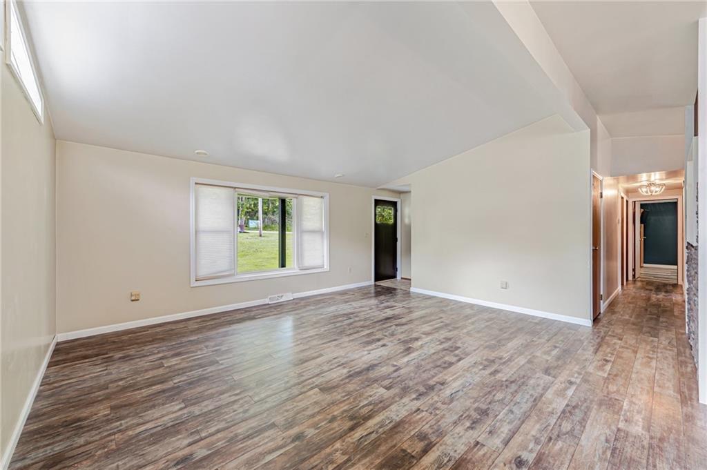812 Buchanan Road White, PA 15490 - Photo 5 of 35 an empty room with wooden floor and windows