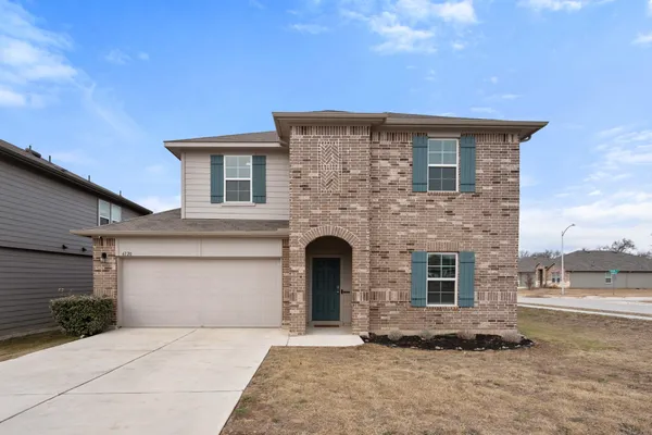 a front view of a house with yard