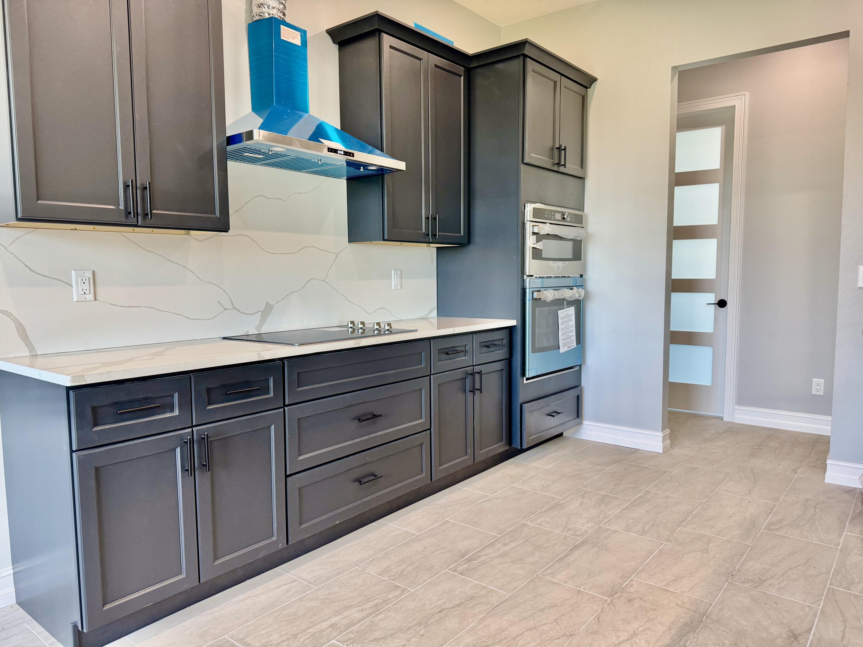 13200 Highway 441 Okeechobee, FL 34974 - Photo 17 of 42 a kitchen with stainless steel appliances granite countertop a refrigerator and a stove