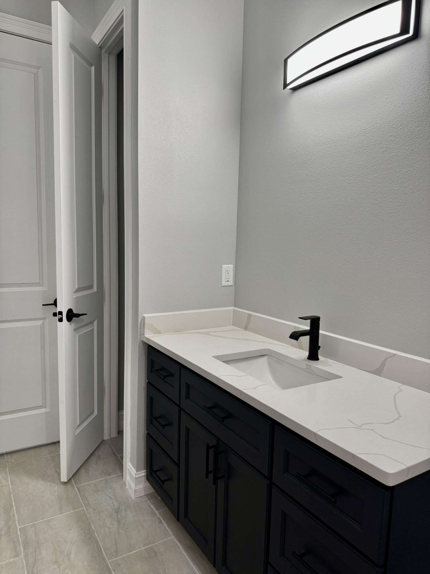 13200 Highway 441 Okeechobee, FL 34974 - Photo 25 of 42 a bathroom with a sink vanity and mirror
