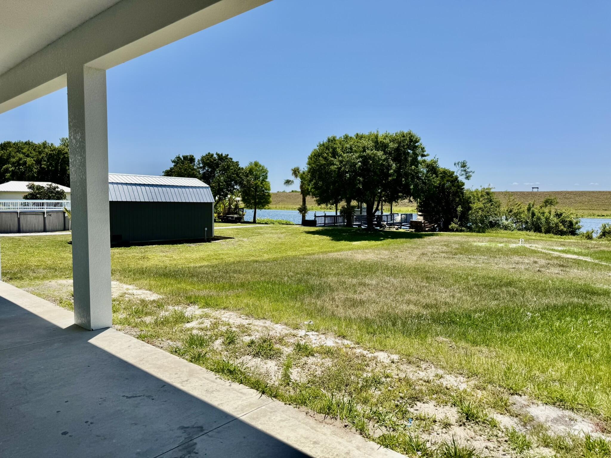 13200 Highway 441 Okeechobee, FL 34974 - Photo 37 of 42 a view of swimming pool with lawn chairs and a big yard