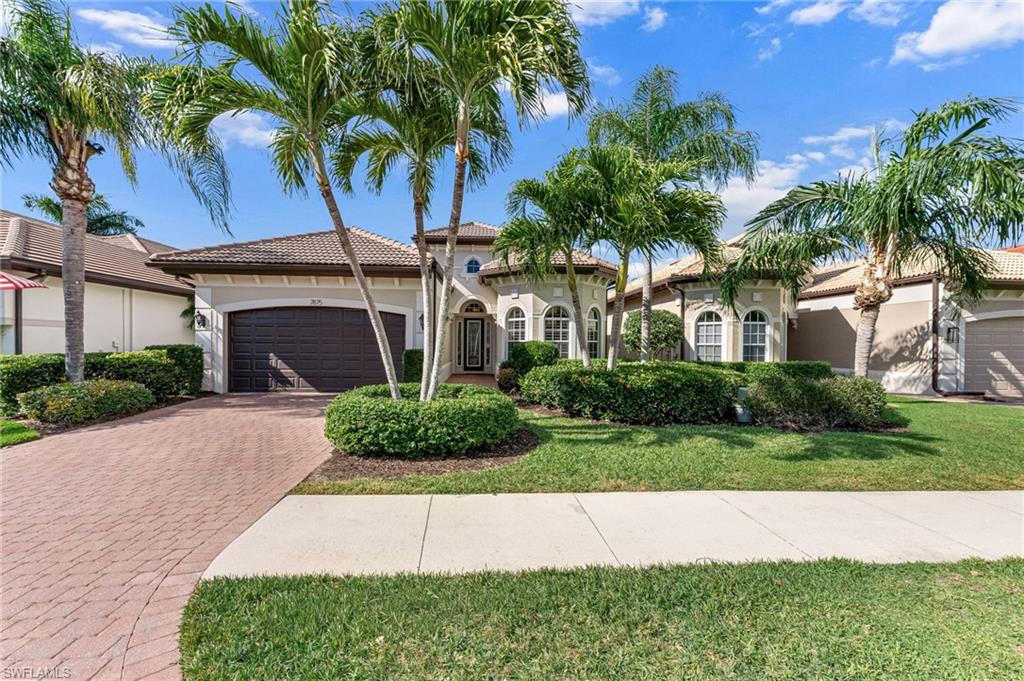 7875 Valencia Court Naples, FL 34113 - Photo 1 of 38 Mediterranea style home featuring a 2-car garage, decorative paver driveway, stucco siding, a tile roof