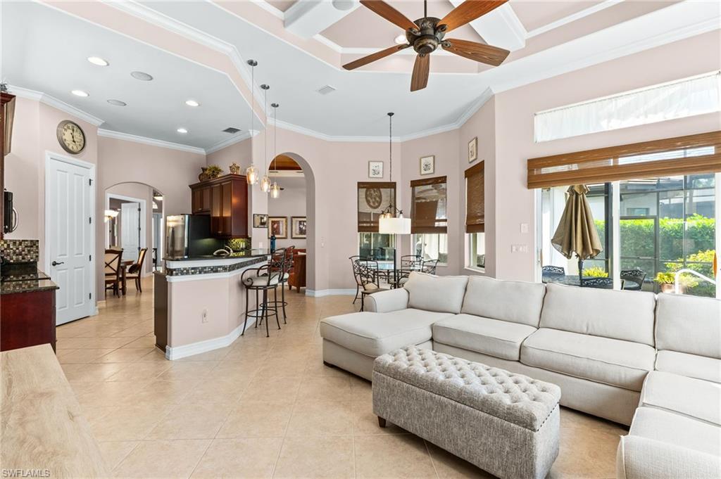 7875 Valencia Court Naples, FL 34113 - Photo 15 of 38 Living area with arched walkways, a ceiling fan, recessed lighting, a high ceiling, and light tile patterned floors