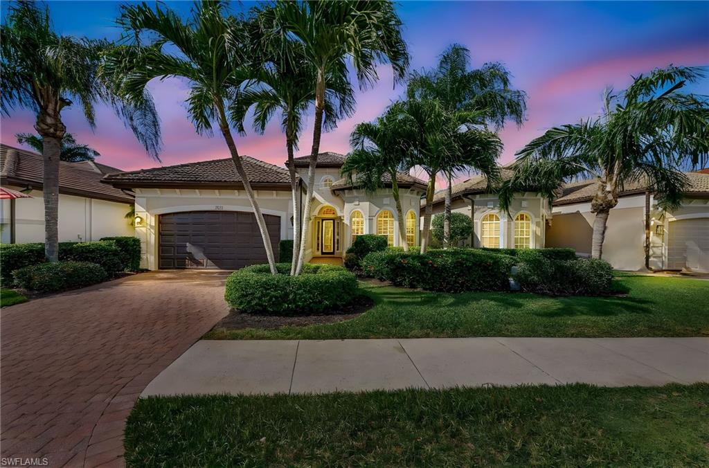 7875 Valencia Court Naples, FL 34113 - Photo 2 of 38 Mediterranean style home featuring a 2-car garage, decorative paver driveway, stucco siding