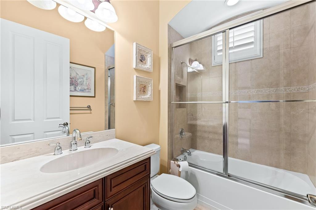 7875 Valencia Court Naples, FL 34113 - Photo 22 of 38 Full bathroom with vanity and combined bath / shower with glass door