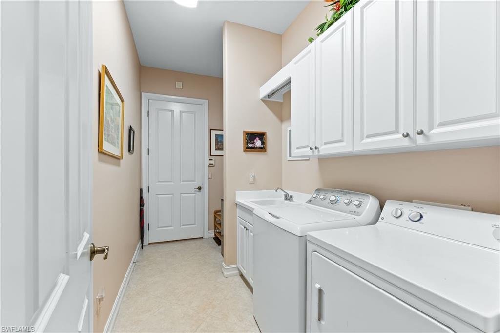 7875 Valencia Court Naples, FL 34113 - Photo 24 of 38 Laundry area featuring cabinet space, separate washer and dryer, and light tile patterned floors