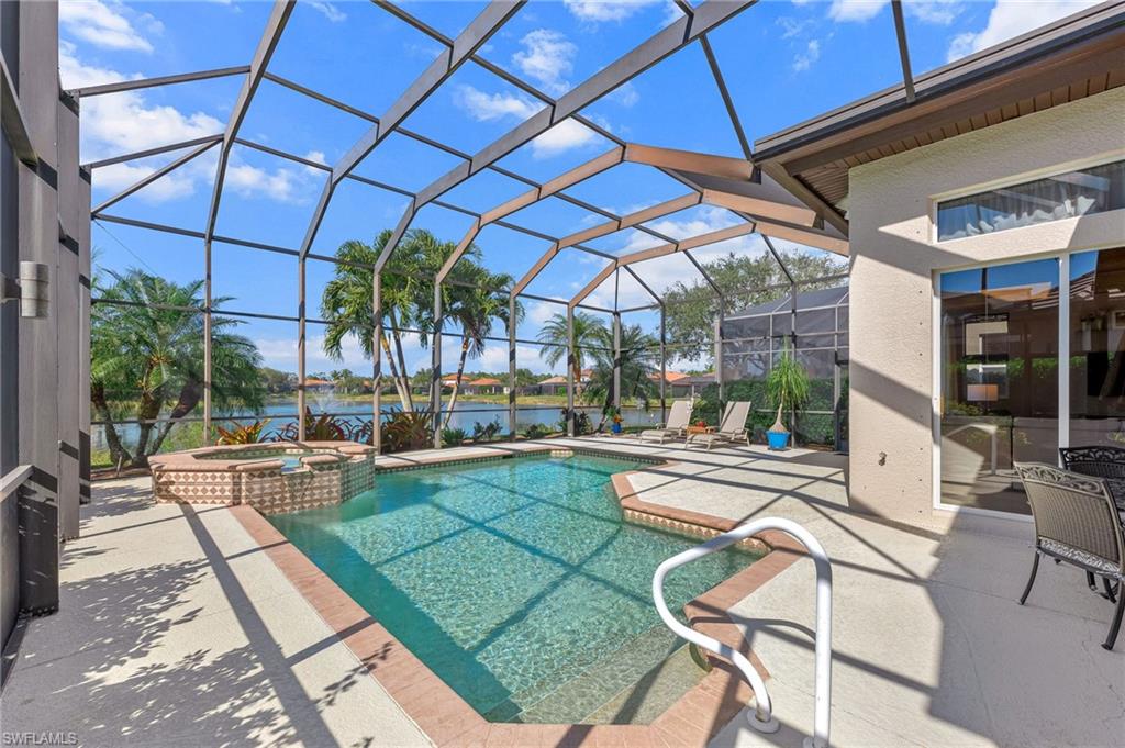 7875 Valencia Court Naples, FL 34113 - Photo 25 of 38 Integrated pool / hot tub featuring a patio area, a lanai and a large lake view