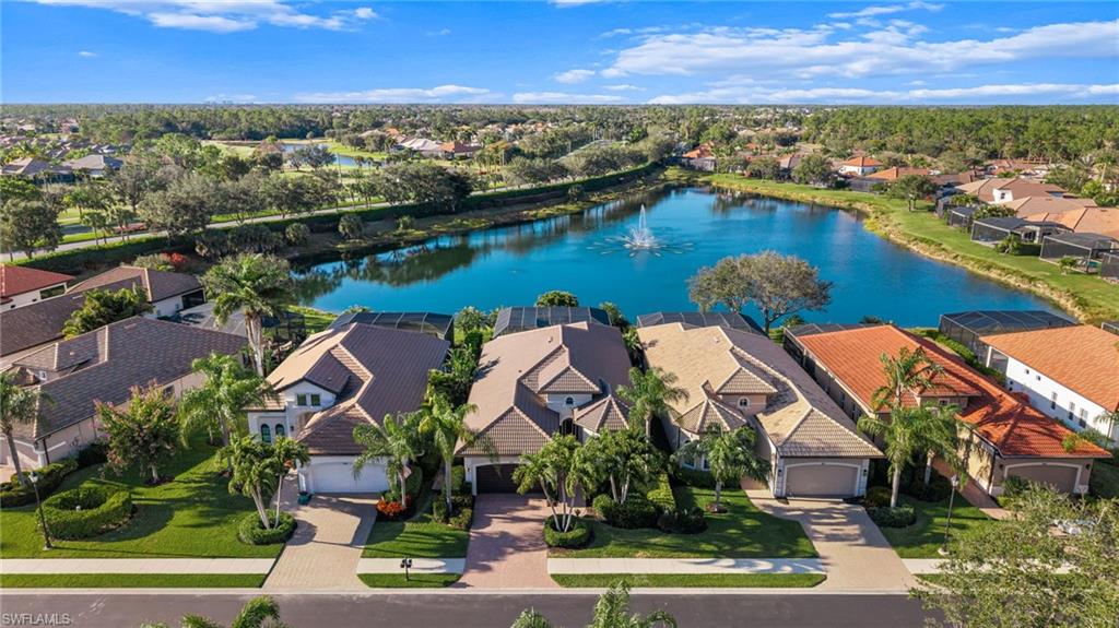 7875 Valencia Court Naples, FL 34113 - Photo 29 of 38 Aerial view of residential area featuring a large lake view