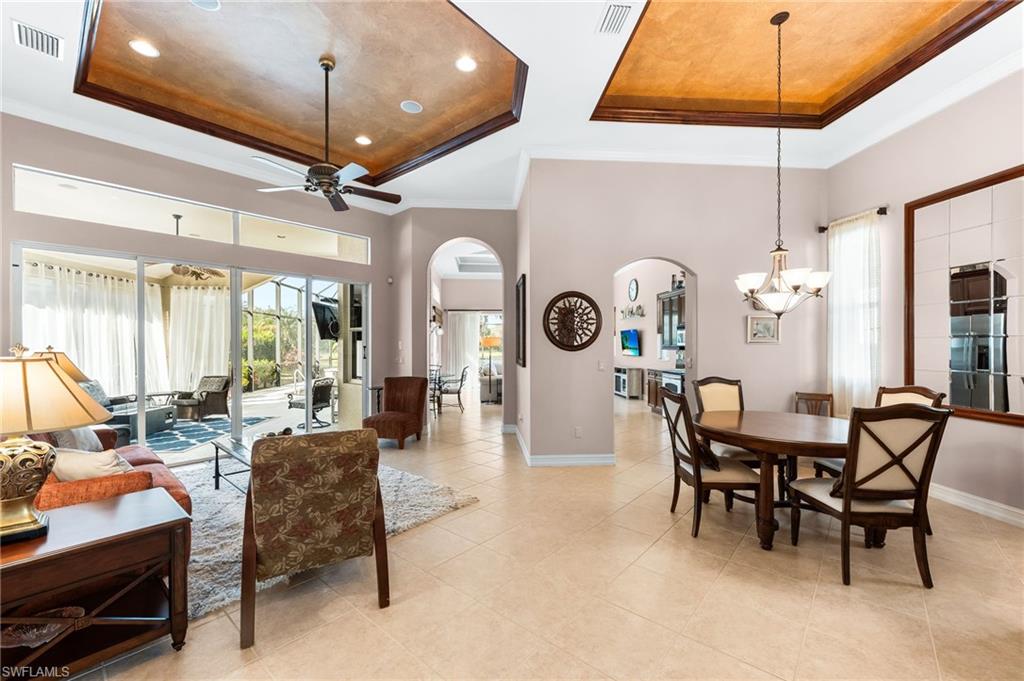 7875 Valencia Court Naples, FL 34113 - Photo 3 of 38 Dining space featuring arched walkways, plenty of natural light, crown molding, a ceiling fan, and recessed lighting