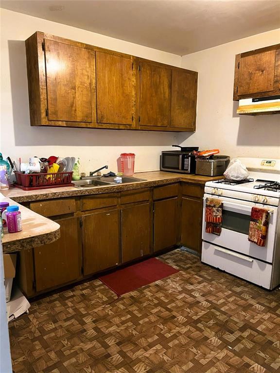 105 James Street Homer, LA 71040 - Photo 11 of 11 a kitchen with stainless steel appliances granite countertop a sink dishwasher stove and cabinets