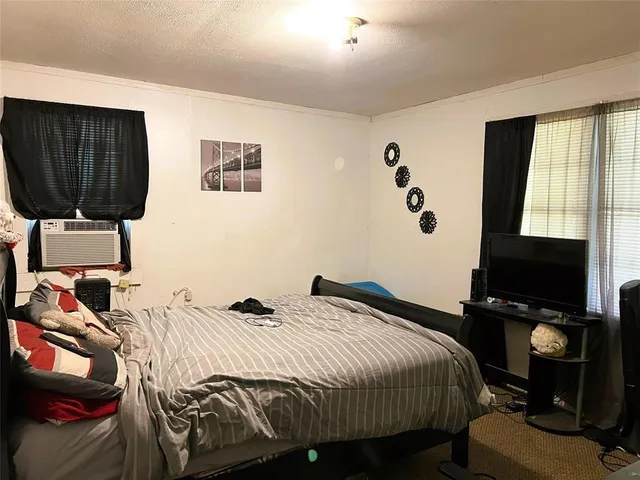 a bedroom with a bed and a television