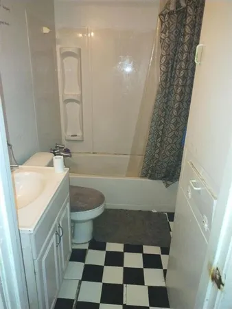 a bathroom with a sink a toilet a shower and a mirror