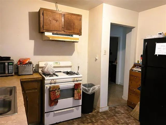 a kitchen with a stove and a refrigerator