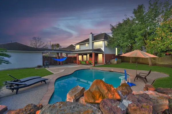 an outdoor space with furniture and umbrella