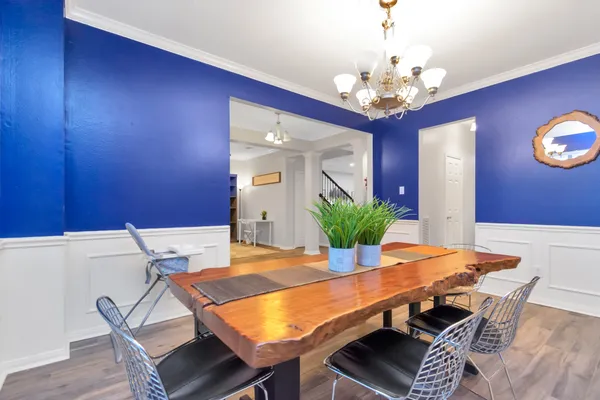 a view of a dining room with furniture and wooden floor