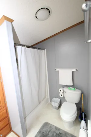 a bathroom with a toilet and a shower curtain