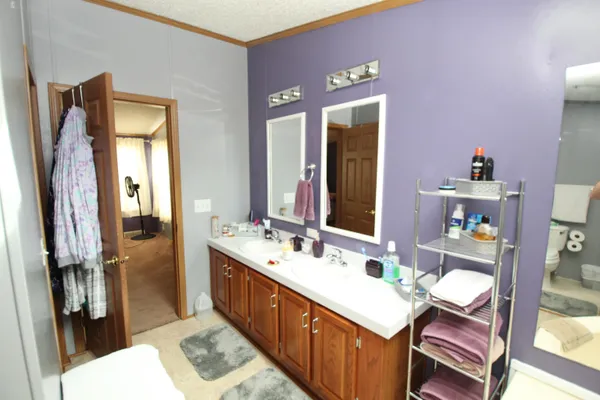 a bathroom with a sink vanity granite and a mirror