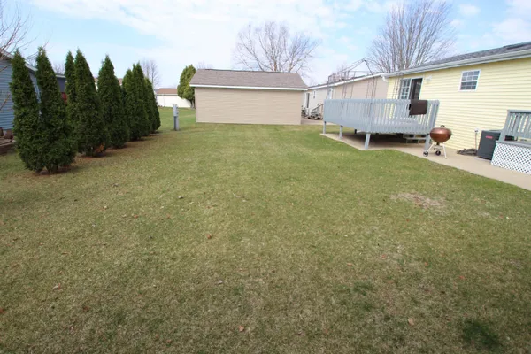 a view of a house with a yard and plants
