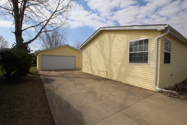a view of a house with a yard and garage