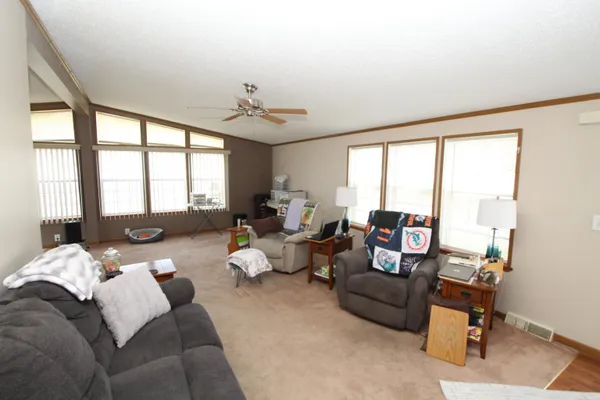 a living room with furniture and large windows