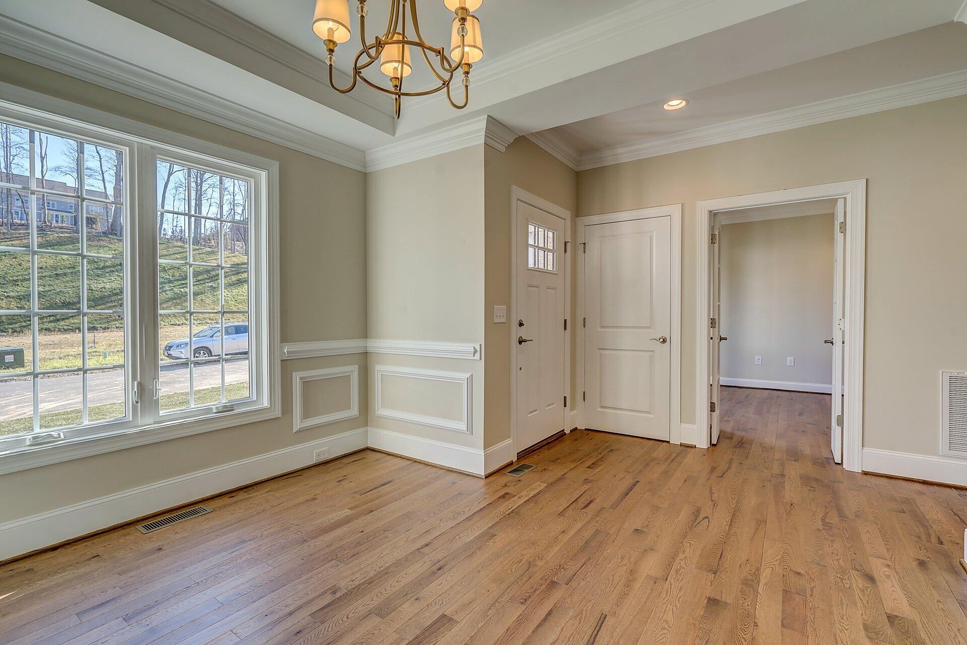 6917 Fairway Ridge Road Salem, VA 24153 - Photo 4 of 12 a view of empty room with wooden floor and fan