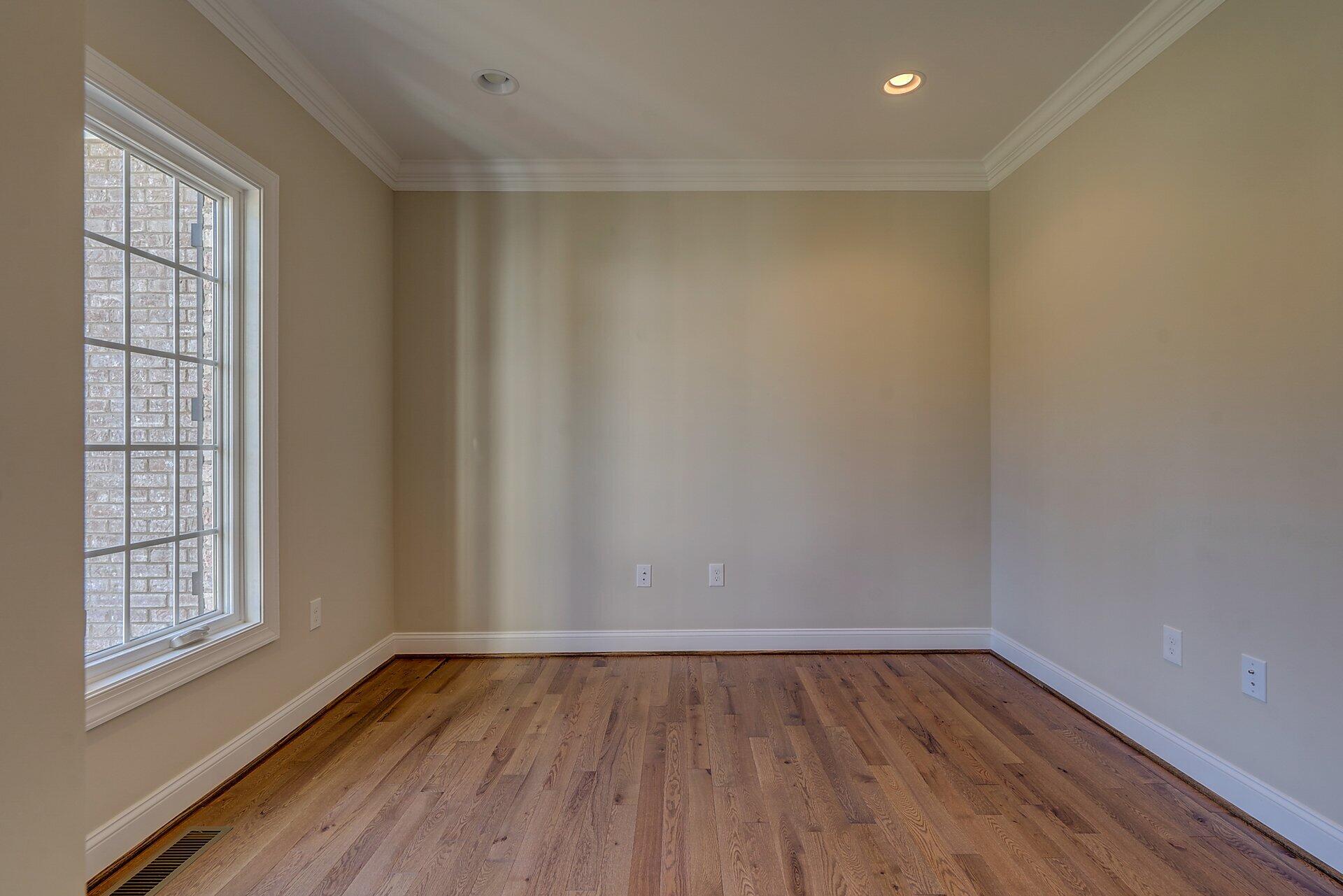 6917 Fairway Ridge Road Salem, VA 24153 - Photo 5 of 12 a view of an empty room with wooden floor and a window