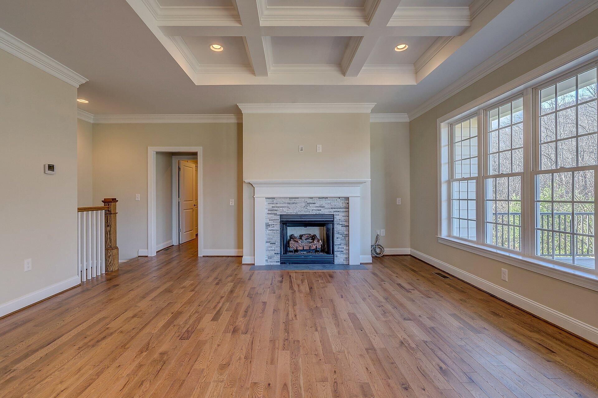 6917 Fairway Ridge Road Salem, VA 24153 - Photo 6 of 12 a view of an empty room with wooden floor fireplace and a window