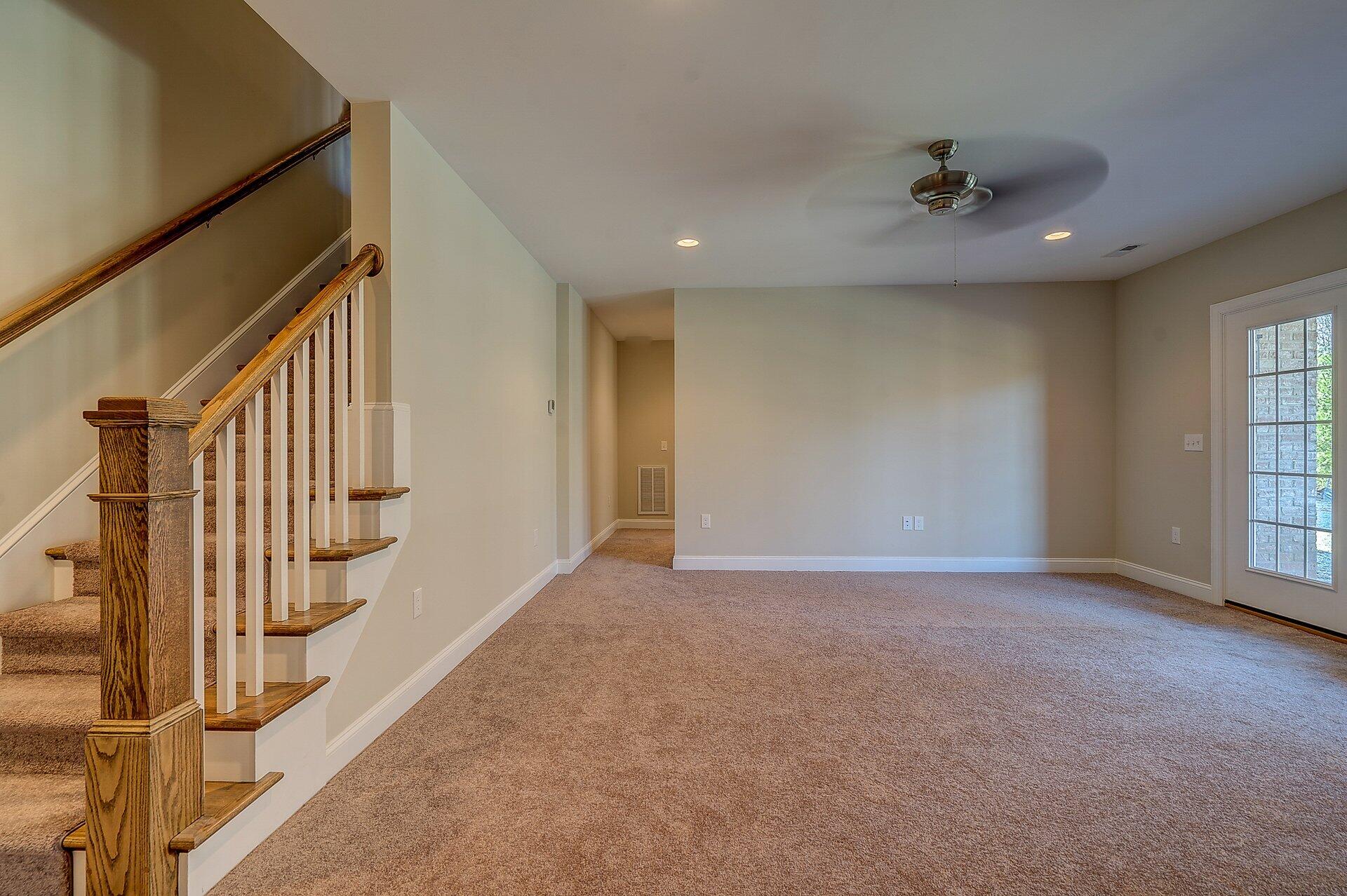 6917 Fairway Ridge Road Salem, VA 24153 - Photo 8 of 12 a view of an empty room with wooden floor and stairs