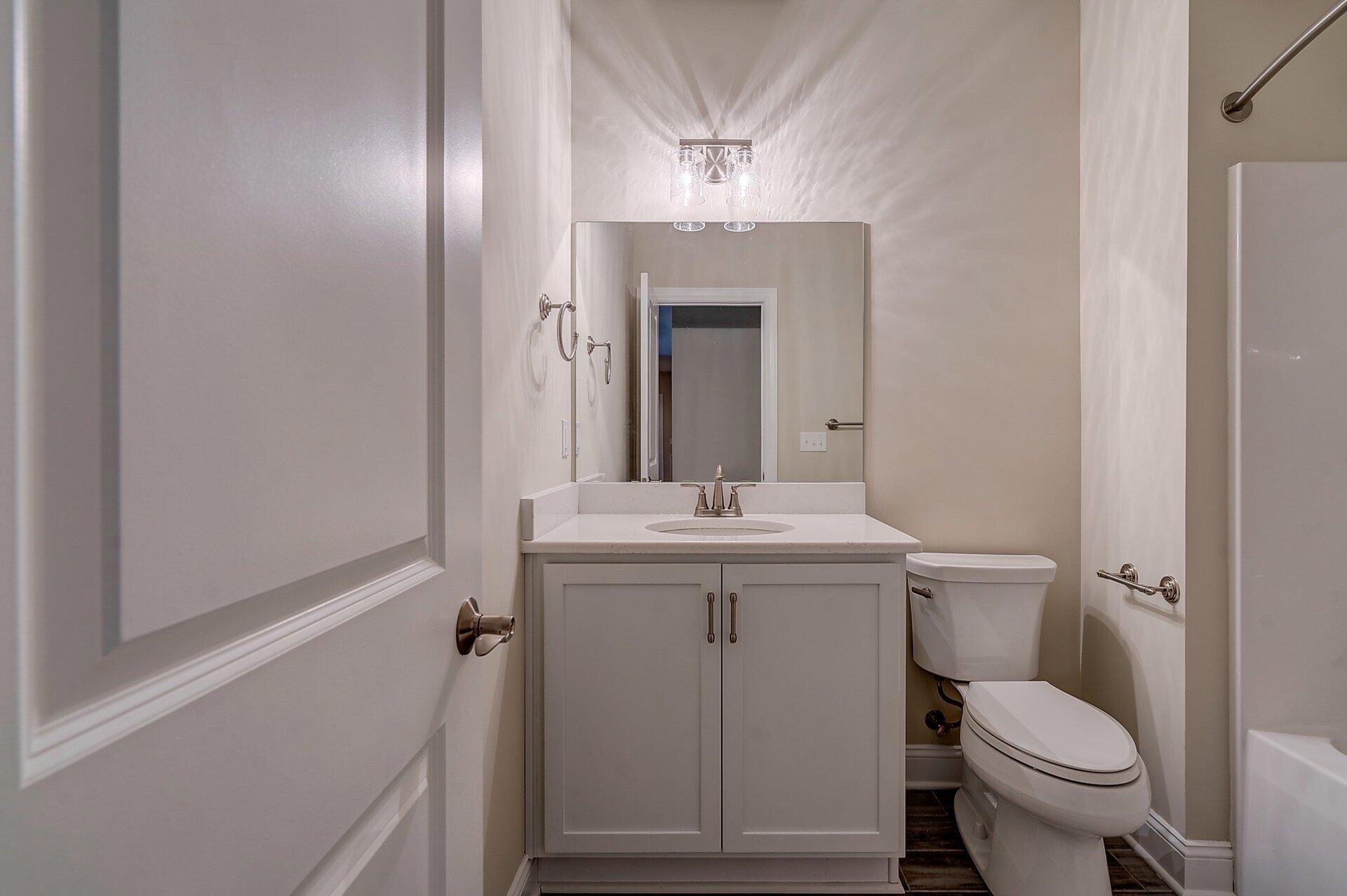 6917 Fairway Ridge Road Salem, VA 24153 - Photo 9 of 12 a bathroom with a toilet a sink and mirror