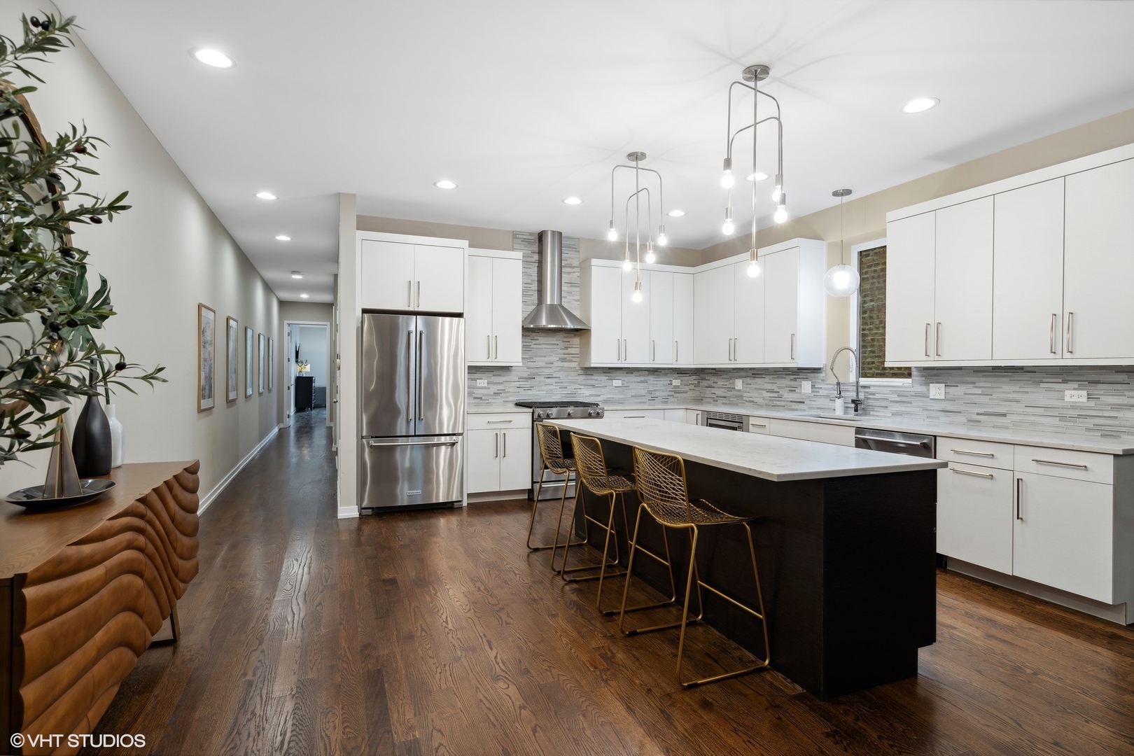 1033 South Racine Avenue, Unit 1S Chicago, IL 60607 - Photo 5 of 29 a kitchen with kitchen island a sink stainless steel appliances and white cabinets