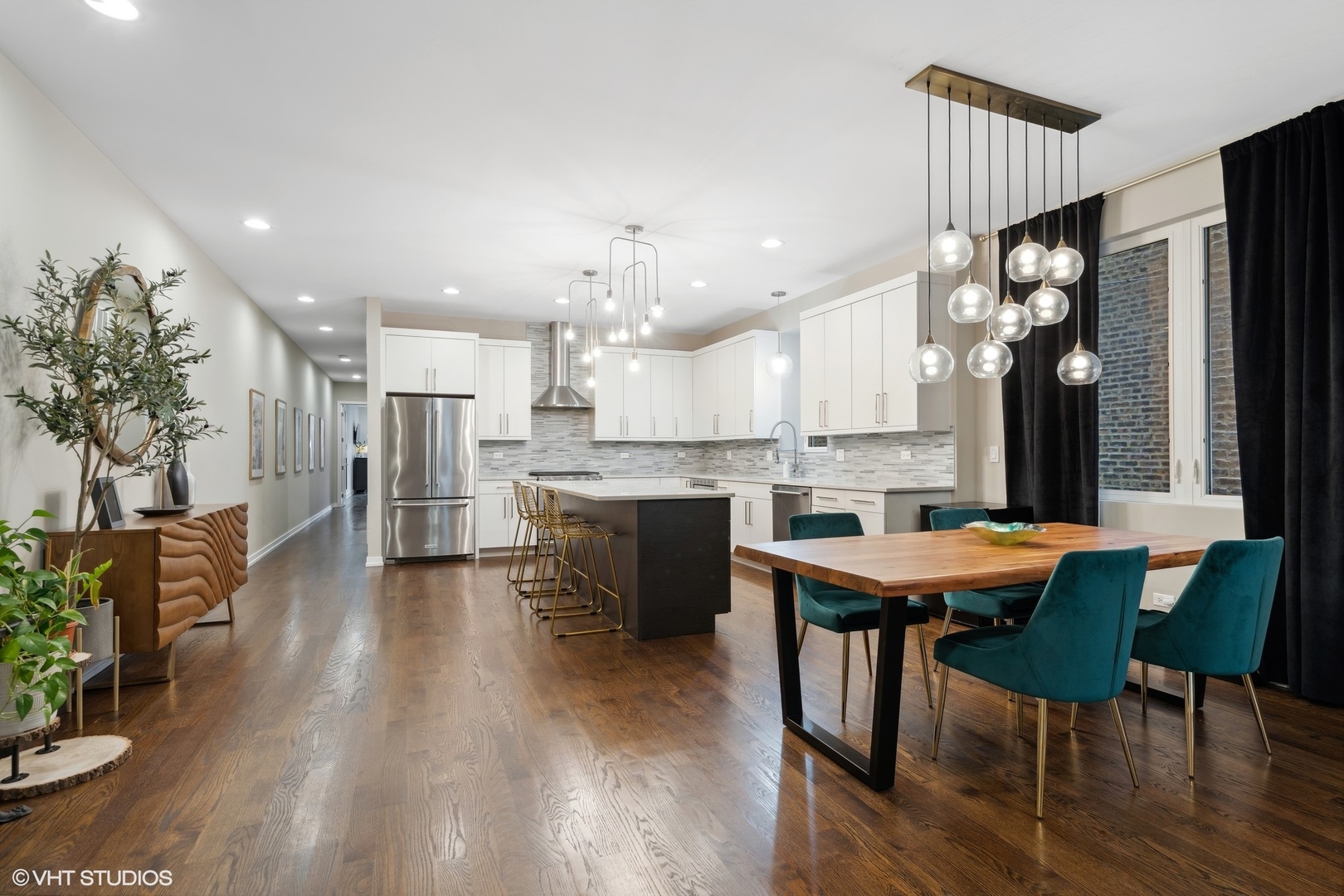 1033 South Racine Avenue, Unit 1S Chicago, IL 60607 - Photo 9 of 29 a kitchen with stainless steel appliances kitchen island granite countertop a table chairs sink and cabinets