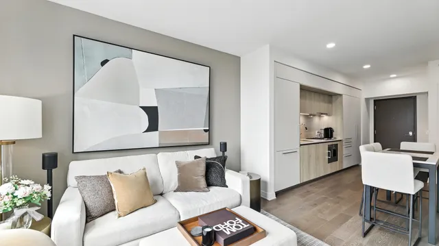 a living room with furniture and a painting