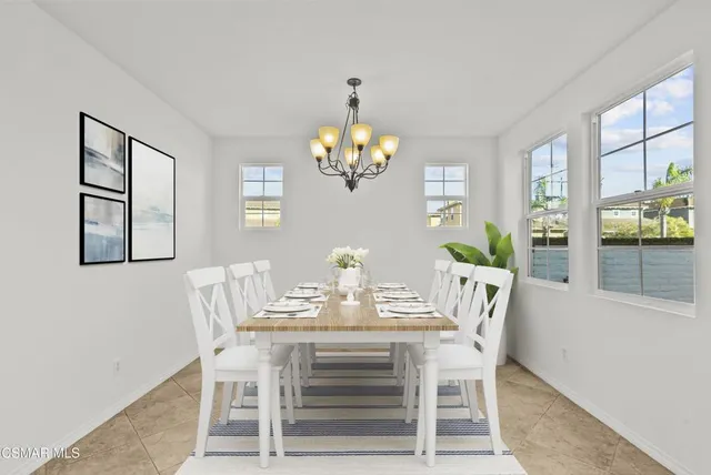 a view of an empty room with a chandelier fan
