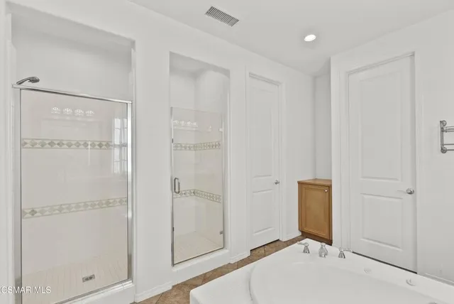 a bathroom with a granite countertop sink mirror toilet and bathtub