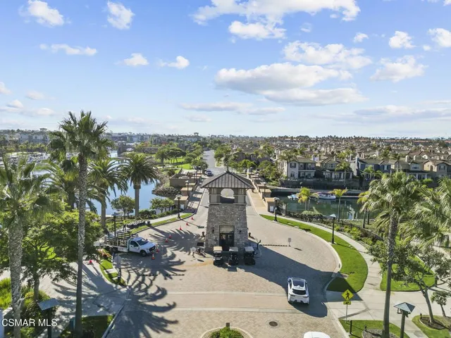 a view of a city with lots of residential buildings ocean and mountain view in back