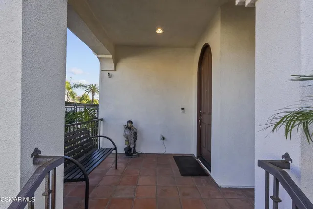a view of a hallway with furniture