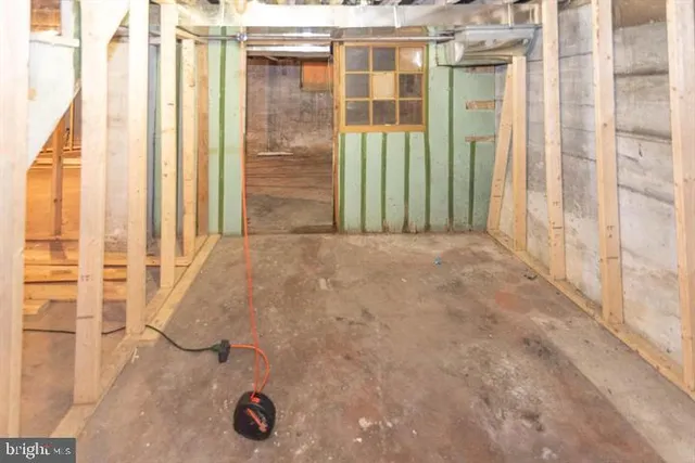 a view of a kitchen with two windows and a table