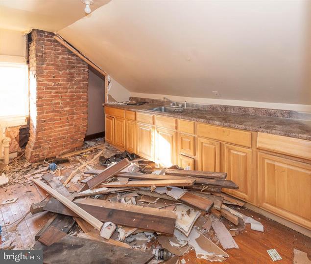 3900 5th Street Baltimore, MD 21225 - Photo 19 of 32 a view of a kitchen with two windows and a table