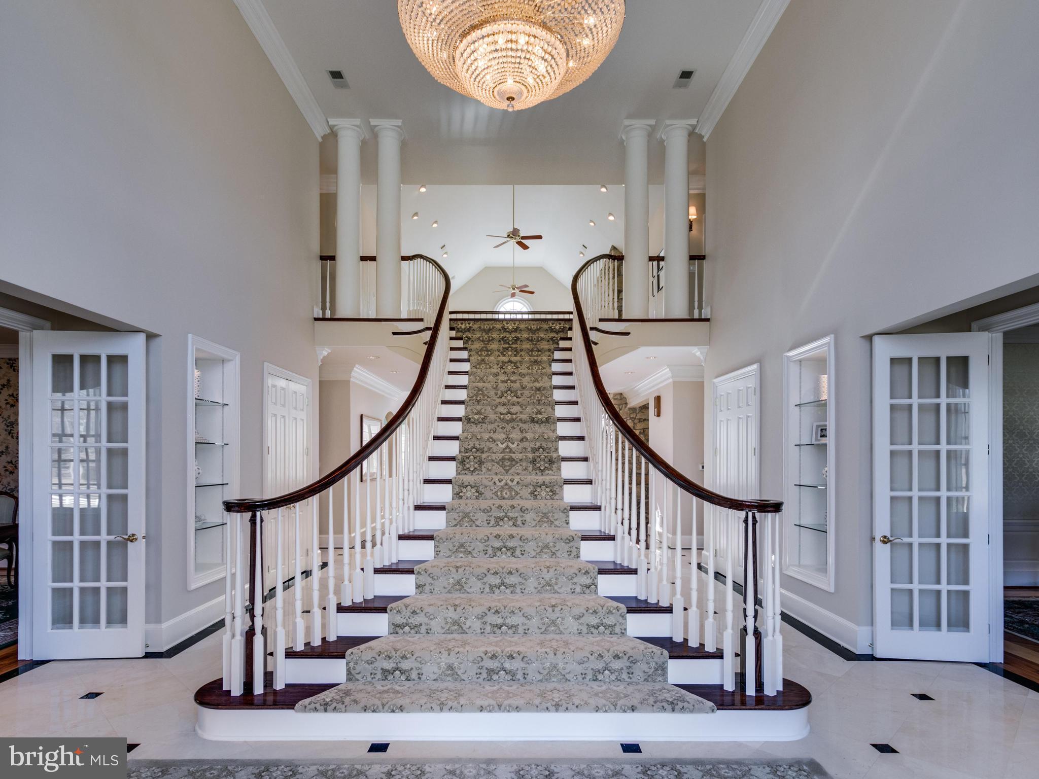 10207 East Hunter Valley Road Vienna, VA 22181 - Photo 2 of 26 DRAMATIC FLOATING STAIRCASE IN TWO-STORY FOYER