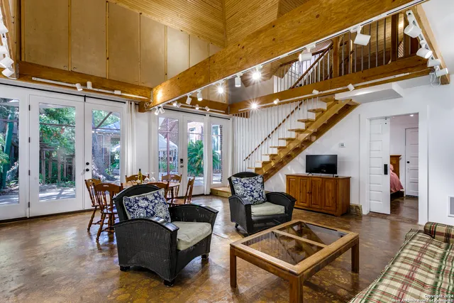 a living room with furniture a rug and a window