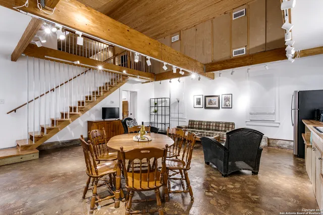a dining room with furniture entryway and wooden floor