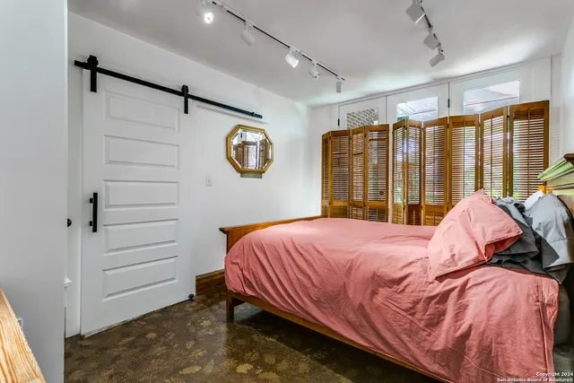 a bedroom with a bed and a window