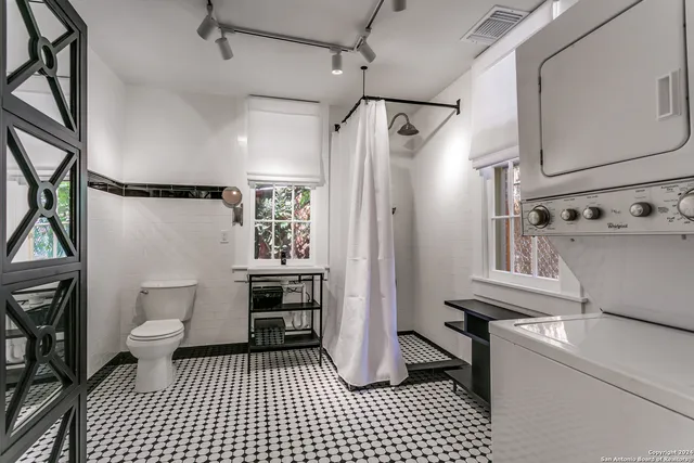a bathroom with a sink a toilet and a shower
